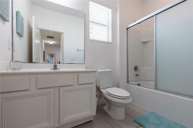 2623 Calistoga Ave, Kissimmee, FL 34741 - full bath with toilet, tile patterned floors, vanity, and bath / shower combo with glass door