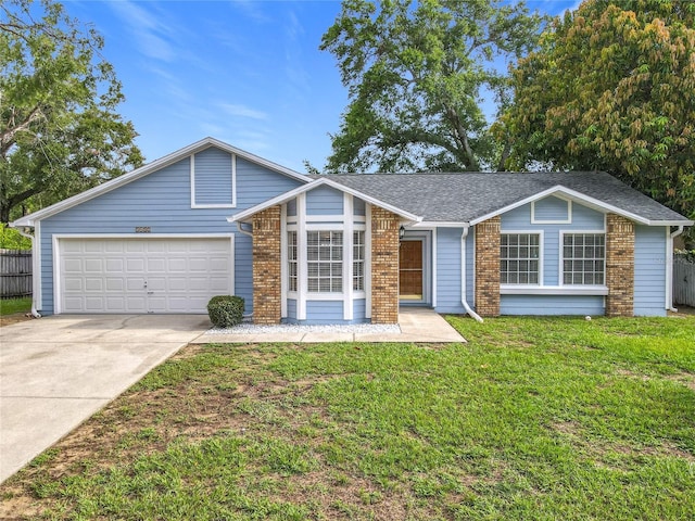 5452 Higgins Way, Orlando, FL 32808 - view of front of house with brick siding, driveway, a garage, and a shingled roof