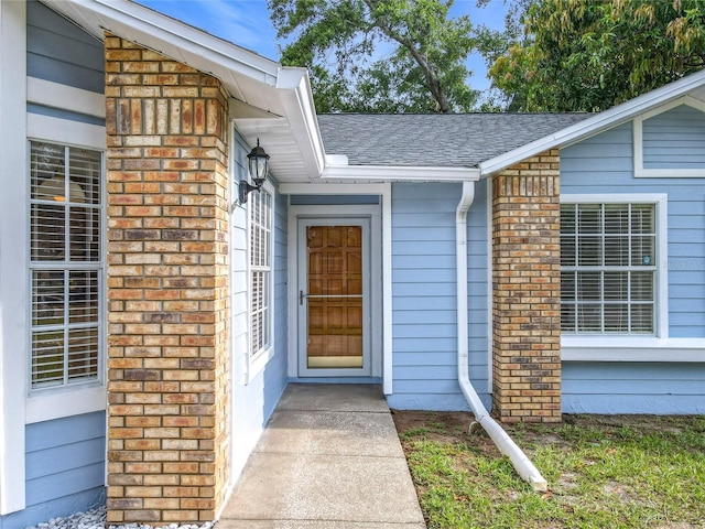 5452 Higgins Way, Orlando, FL 32808 - property entrance with brick siding and roof with shingles