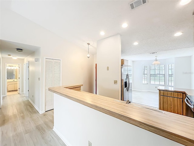 5452 Higgins Way, Orlando, FL 32808 - corridor featuring baseboards, light wood-style floors, lofted ceiling, and recessed lighting
