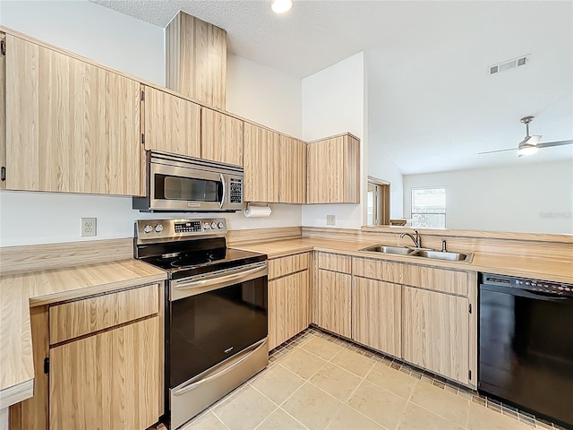 5452 Higgins Way, Orlando, FL 32808 - kitchen featuring stainless steel appliances, light brown cabinetry, a sink, and ceiling fan