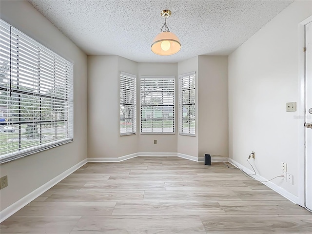 5452 Higgins Way, Orlando, FL 32808 - unfurnished room featuring a textured ceiling, light wood-style flooring, and baseboards
