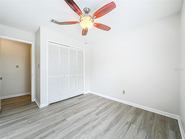 5452 Higgins Way, Orlando, FL 32808 - unfurnished bedroom featuring a closet, light wood-style flooring, baseboards, and ceiling fan