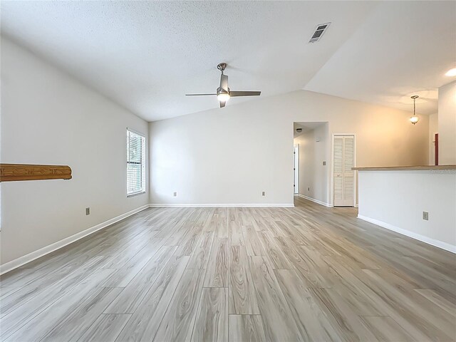 5452 Higgins Way, Orlando, FL 32808 - empty room featuring ceiling fan, light wood-style flooring, baseboards, and vaulted ceiling
