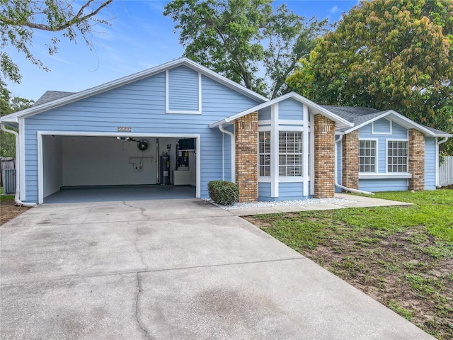5452 Higgins Way, Orlando, FL 32808 - view of front of property featuring concrete driveway, an attached garage, electric water heater, central AC, and brick siding