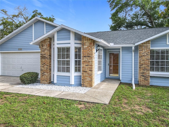 5452 Higgins Way, Orlando, FL 32808 - view of front of house with brick siding, roof with shingles, a garage, driveway, and a front lawn