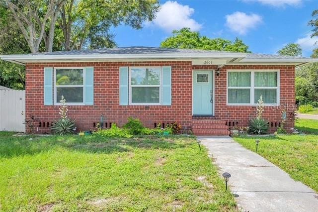 2601 Upton St S, Gulfport, FL 33711 - bungalow-style home with a front yard, brick siding, and entry steps