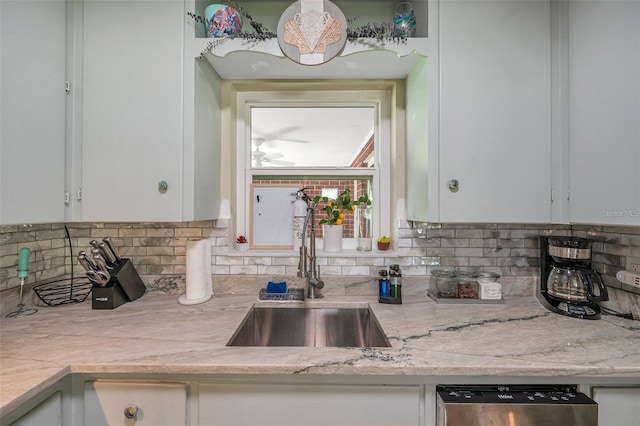 2601 Upton St S, Gulfport, FL 33711 - kitchen featuring a sink, stainless steel dishwasher, white cabinetry, decorative backsplash, and ceiling fan