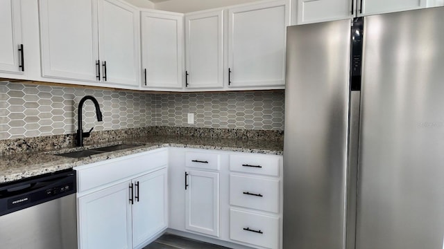 4546 Ontario Dr, New Port Richey, FL 34652 - kitchen with appliances with stainless steel finishes, a sink, white cabinetry, and light stone counters