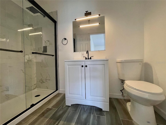 4546 Ontario Dr, New Port Richey, FL 34652 - full bathroom featuring toilet, a shower stall, baseboards, vanity, and wood finish floors
