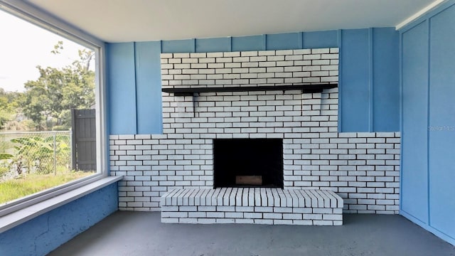 4546 Ontario Dr, New Port Richey, FL 34652 - detailed view of unfinished concrete flooring and a brick fireplace