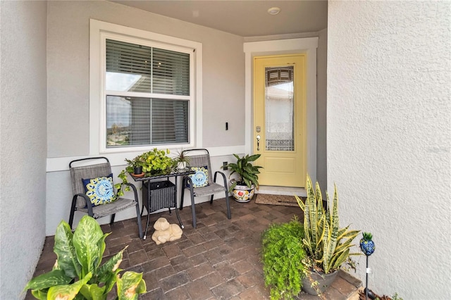 entrance to property with stucco siding