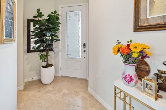 foyer with baseboards and light tile patterned flooring