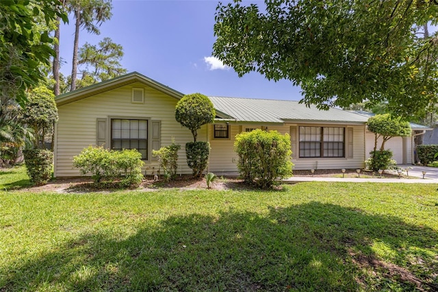 4307 Oak Ct, Saint Cloud, FL 34769 - single story home with an attached garage, a front lawn, and metal roof