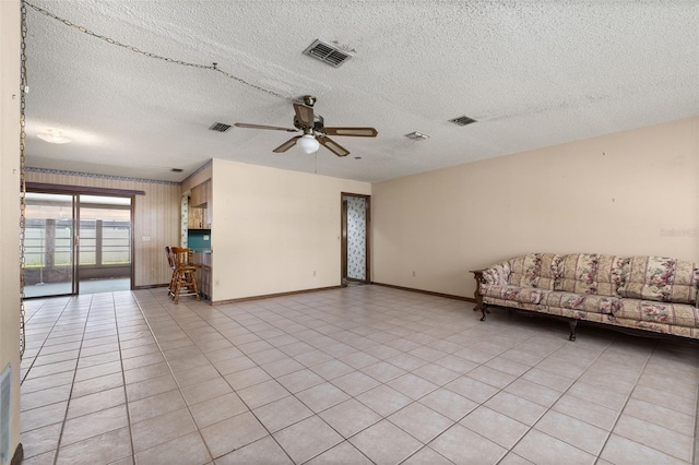 4307 Oak Ct, Saint Cloud, FL 34769 - unfurnished living room featuring baseboards, ceiling fan, and a textured ceiling