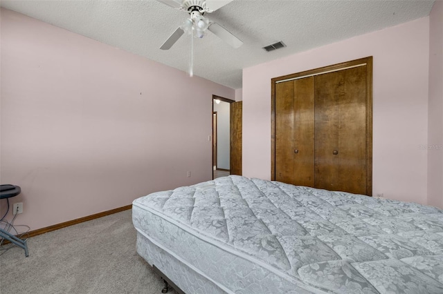 4307 Oak Ct, Saint Cloud, FL 34769 - carpeted bedroom with a closet, a textured ceiling, baseboards, and a ceiling fan
