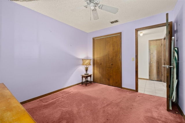 4307 Oak Ct, Saint Cloud, FL 34769 - unfurnished bedroom with carpet, a textured ceiling, baseboards, a ceiling fan, and a closet