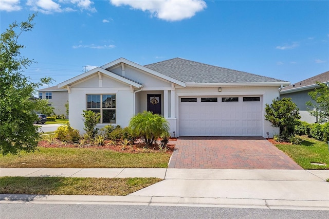 6651 Syreeta Ln, Harmony, FL 34773 - single story home featuring decorative driveway, a garage, stucco siding, and a shingled roof