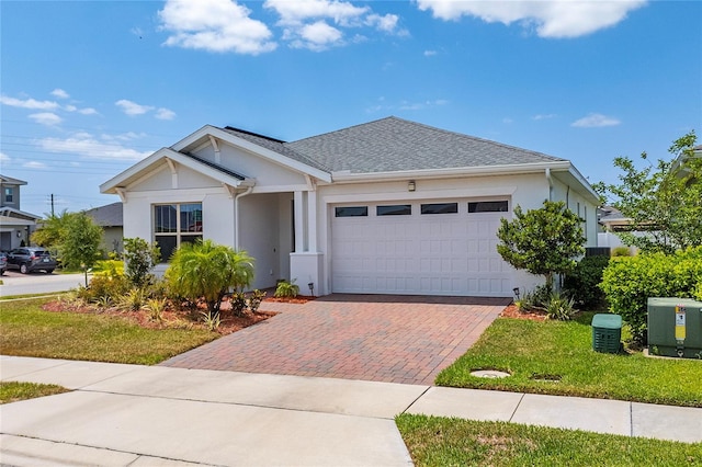 6651 Syreeta Ln, Harmony, FL 34773 - ranch-style house featuring decorative driveway, an attached garage, stucco siding, and roof with shingles