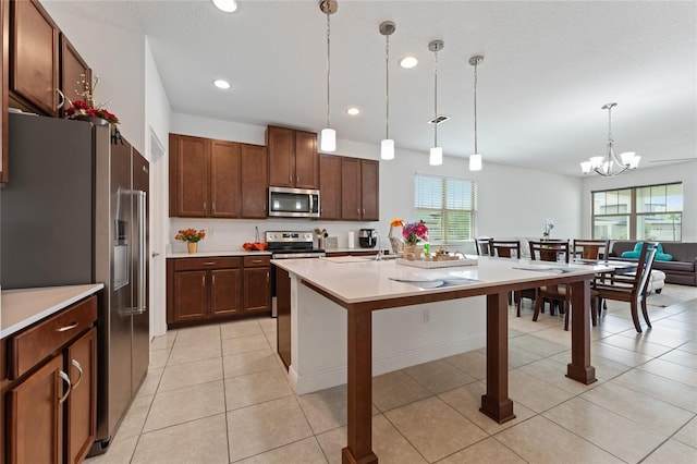 6651 Syreeta Ln, Harmony, FL 34773 - kitchen with stainless steel appliances, light countertops, a chandelier, hanging light fixtures, and recessed lighting