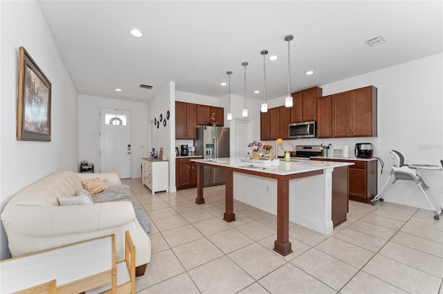 6651 Syreeta Ln, Harmony, FL 34773 - kitchen featuring stainless steel appliances, light countertops, light tile patterned floors, recessed lighting, and pendant lighting