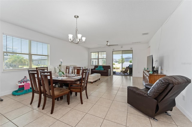 6651 Syreeta Ln, Harmony, FL 34773 - dining area featuring light tile patterned floors, a chandelier, baseboards, and a ceiling fan