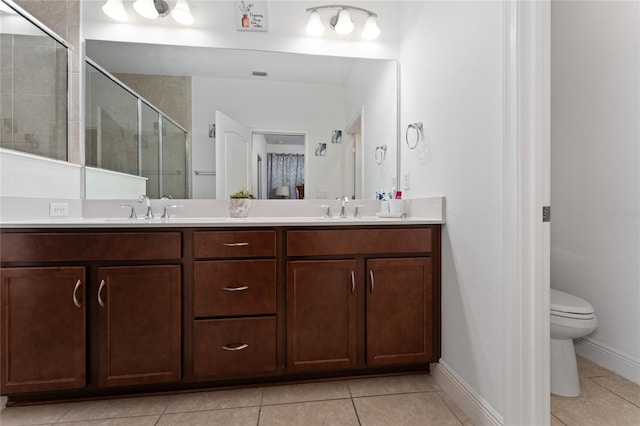 6651 Syreeta Ln, Harmony, FL 34773 - bathroom with tile patterned flooring, double vanity, a shower stall, and toilet