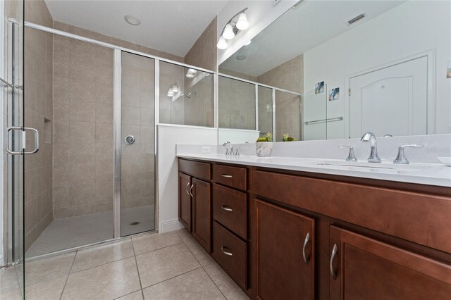 6651 Syreeta Ln, Harmony, FL 34773 - full bath featuring double vanity, tile patterned floors, and a stall shower