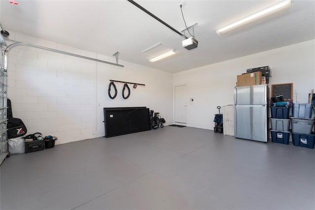 6651 Syreeta Ln, Harmony, FL 34773 - garage with freestanding refrigerator and a garage door opener
