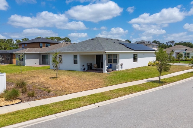 6651 Syreeta Ln, Harmony, FL 34773 - back of property featuring stucco siding and a lawn