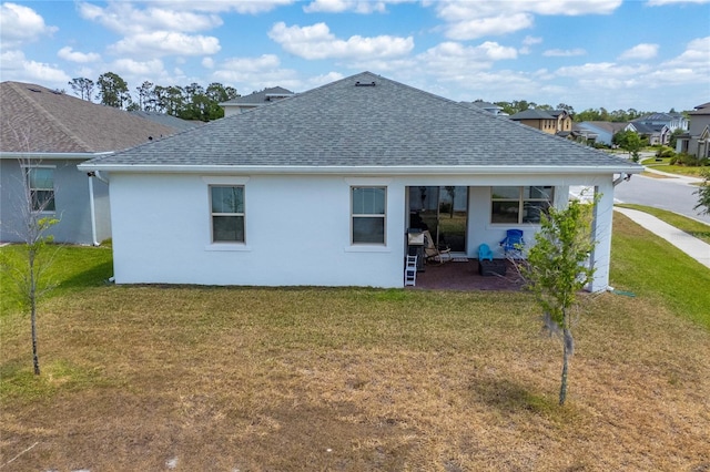 6651 Syreeta Ln, Harmony, FL 34773 - back of property with a shingled roof, a yard, and stucco siding
