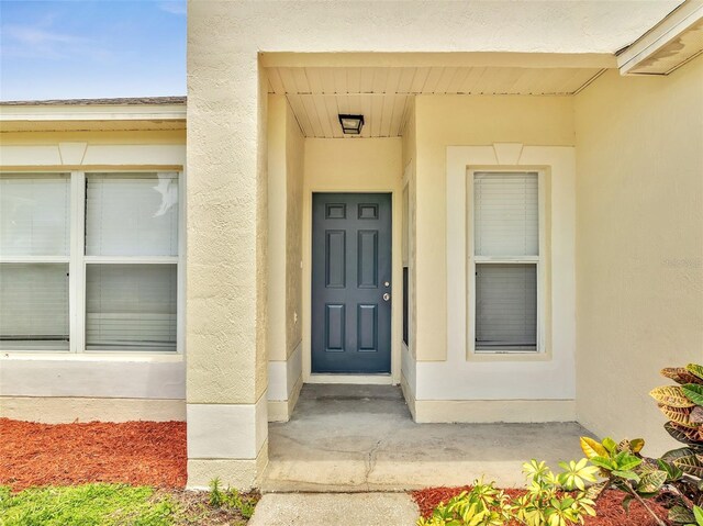 3274 Hunters Chase Loop, Kissimmee, FL 34743 - doorway to property with stucco siding