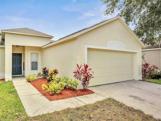 3274 Hunters Chase Loop, Kissimmee, FL 34743 - view of front of property featuring an attached garage, stucco siding, driveway, and roof with shingles