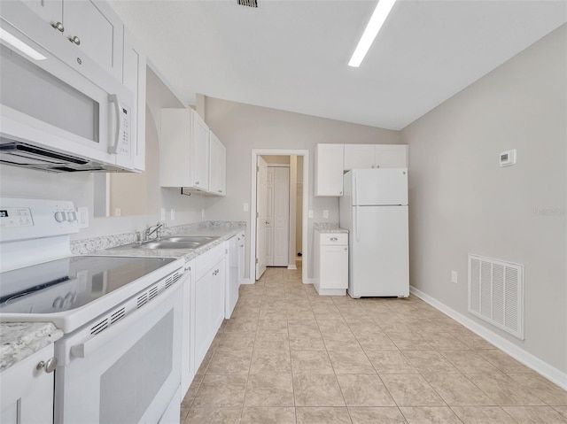 3274 Hunters Chase Loop, Kissimmee, FL 34743 - kitchen featuring white appliances, a sink, lofted ceiling, white cabinets, and baseboards
