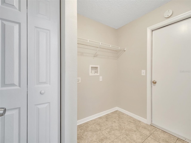 3274 Hunters Chase Loop, Kissimmee, FL 34743 - laundry room with washer hookup, baseboards, a textured ceiling, and light tile patterned flooring