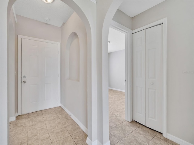 3274 Hunters Chase Loop, Kissimmee, FL 34743 - entryway with baseboards, light tile patterned flooring, and arched walkways