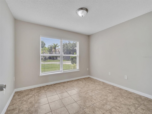 3274 Hunters Chase Loop, Kissimmee, FL 34743 - empty room featuring a textured ceiling, light tile patterned floors, and baseboards