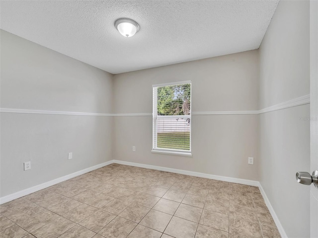 3274 Hunters Chase Loop, Kissimmee, FL 34743 - empty room with a textured ceiling, light tile patterned floors, and baseboards