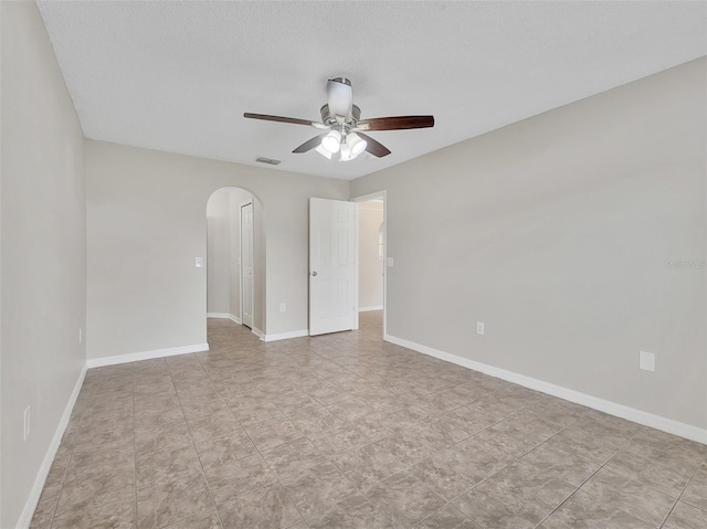 3274 Hunters Chase Loop, Kissimmee, FL 34743 - empty room featuring arched walkways, ceiling fan, baseboards, and a textured ceiling