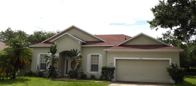 3074 Bay Laurel Cir N, Kissimmee, FL 34744 - mediterranean / spanish-style house featuring an attached garage, driveway, stucco siding, and roof with shingles