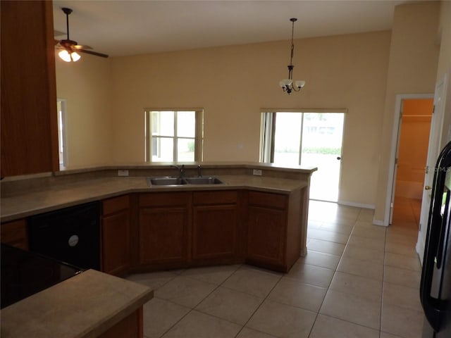 3074 Bay Laurel Cir N, Kissimmee, FL 34744 - kitchen featuring a sink, light tile patterned flooring, pendant lighting, brown cabinets, and light countertops