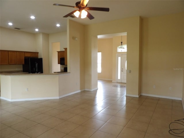 3074 Bay Laurel Cir N, Kissimmee, FL 34744 - kitchen with black appliances, a ceiling fan, light tile patterned flooring, brown cabinetry, and recessed lighting