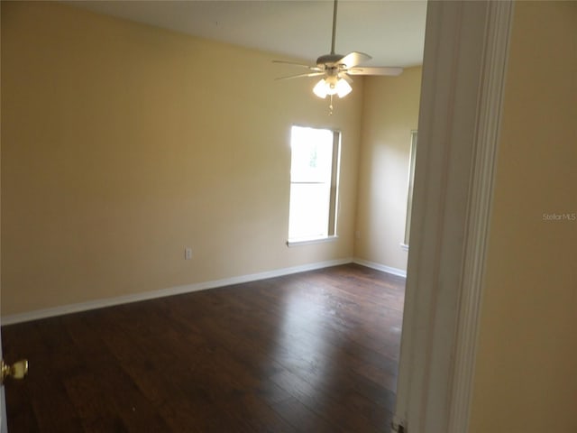 3074 Bay Laurel Cir N, Kissimmee, FL 34744 - spare room with dark wood-style flooring, a ceiling fan, and baseboards