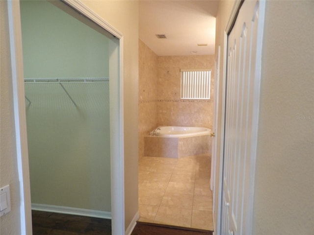 3074 Bay Laurel Cir N, Kissimmee, FL 34744 - bathroom with a garden tub and tile patterned flooring