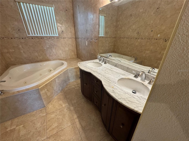 3074 Bay Laurel Cir N, Kissimmee, FL 34744 - bathroom featuring tile walls, a jetted tub, double vanity, and tile patterned flooring