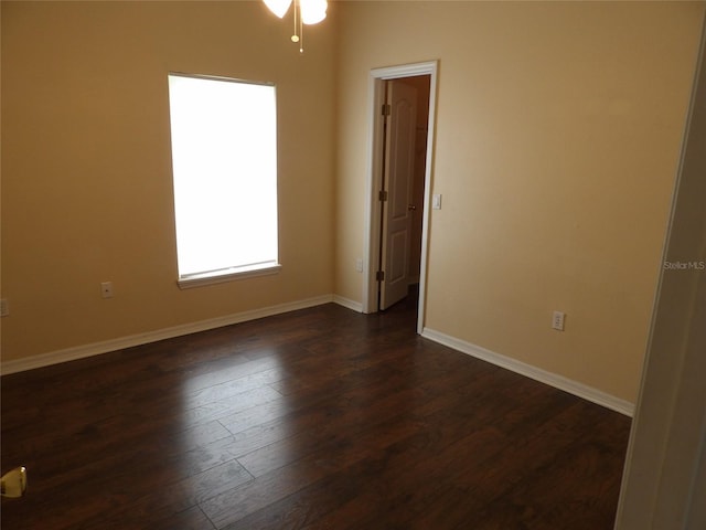 3074 Bay Laurel Cir N, Kissimmee, FL 34744 - spare room featuring dark wood-style flooring, baseboards, and a ceiling fan