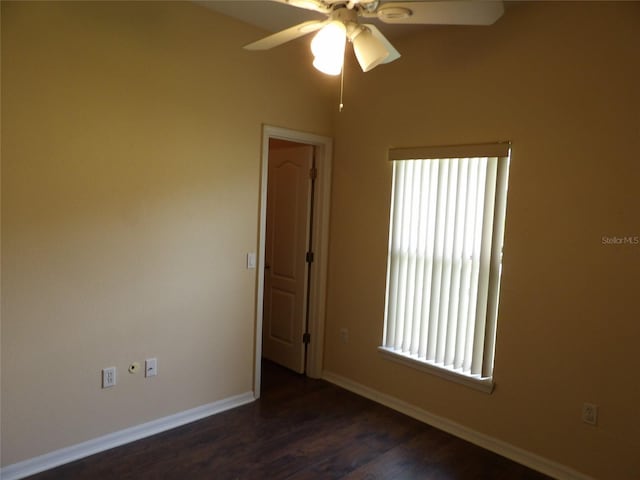 3074 Bay Laurel Cir N, Kissimmee, FL 34744 - unfurnished room featuring a ceiling fan, healthy amount of natural light, baseboards, and dark wood-type flooring