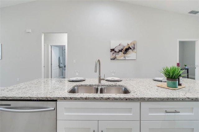 515 Everest Way, Kissimmee, FL 34758 - kitchen featuring stainless steel dishwasher, a sink, white cabinets, and light stone countertops