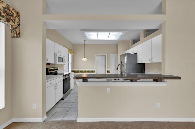 4065 Kingsley St, Clermont, FL 34711 - kitchen featuring appliances with stainless steel finishes, a peninsula, white cabinetry, pendant lighting, and light tile patterned flooring