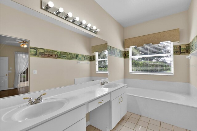 4065 Kingsley St, Clermont, FL 34711 - full bath featuring a bath, double vanity, and tile patterned flooring